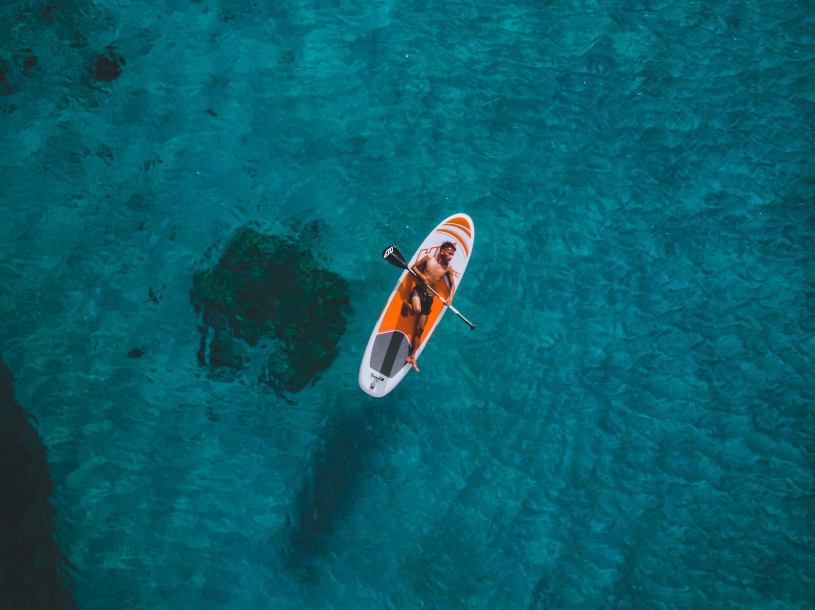 Aerial view of a kayak in clear water off Rote Island, Indonesia