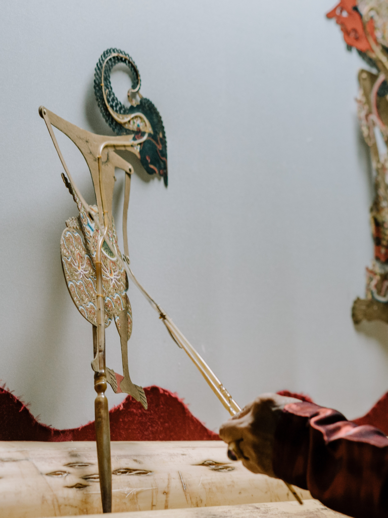 Traditional wayang kulit puppet during an Indonesian shadow puppet performance.