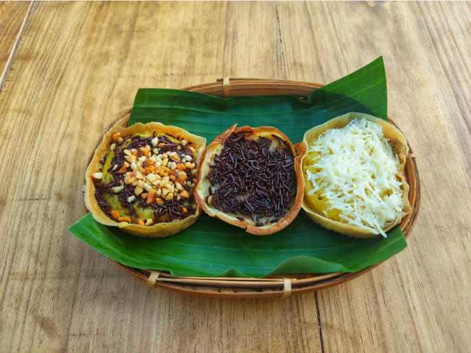 Serabi or surabi, traditional Indonesian rice pancakes with sweet toppings