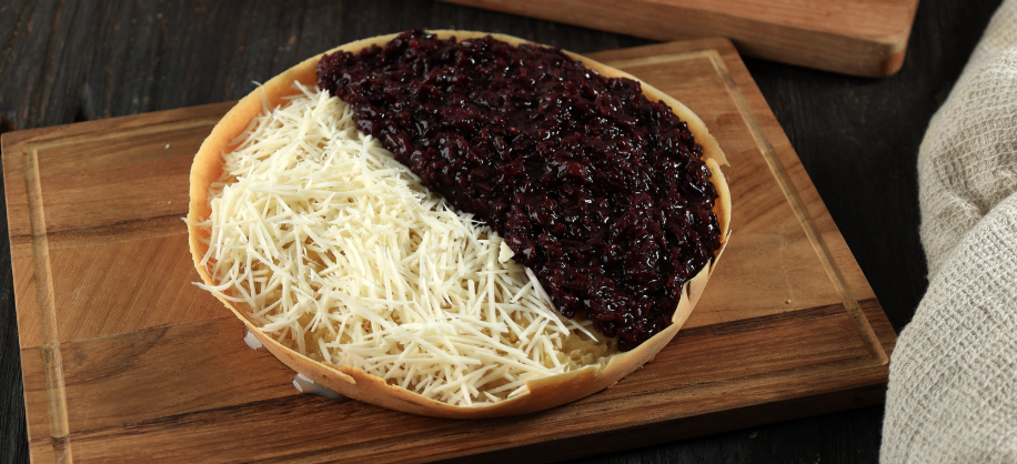 Martabak manis topped with chocolate sprinkles and grated cheese