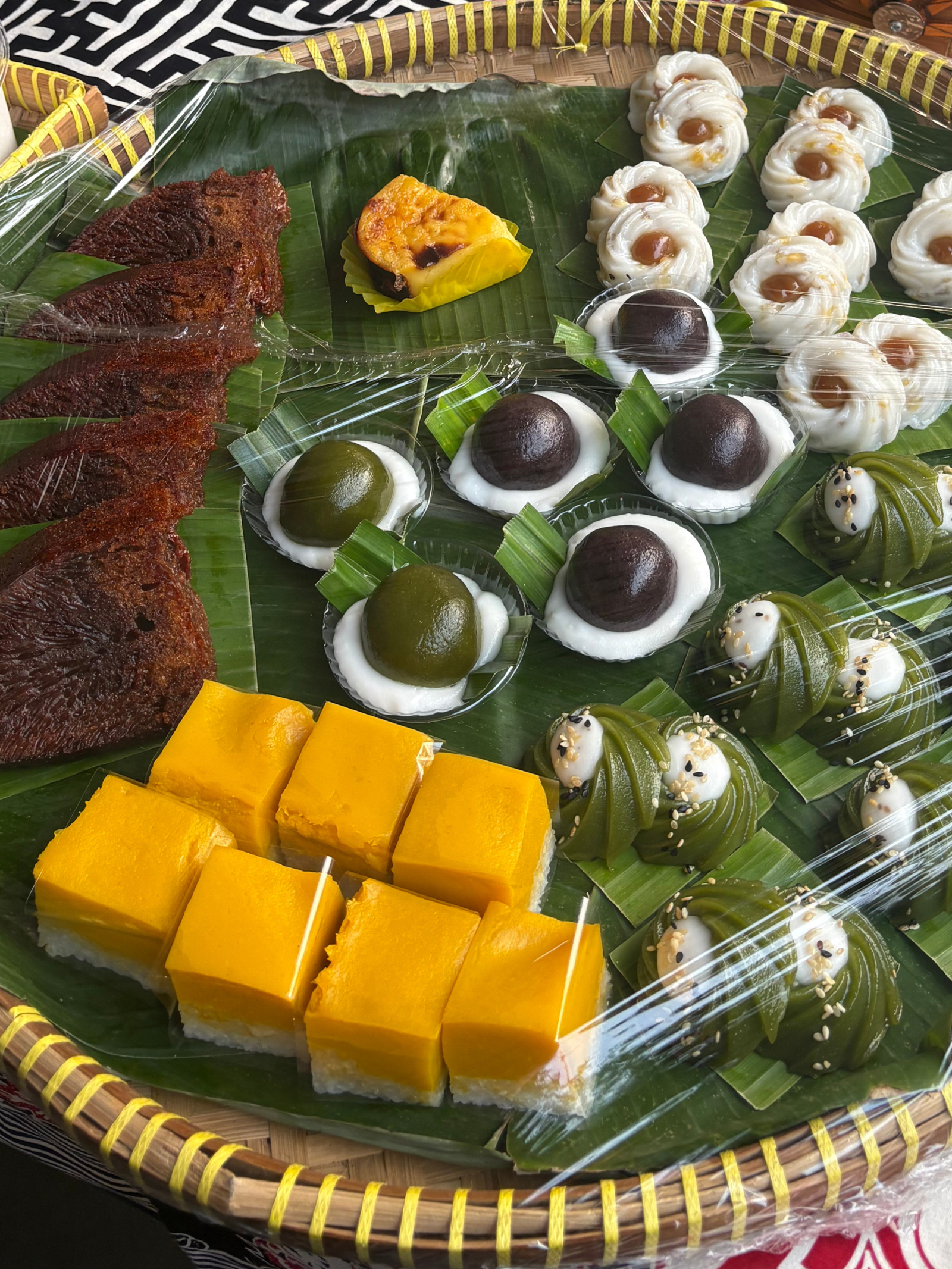 Traditional Indonesian desserts and sweet snacks displayed at a local market