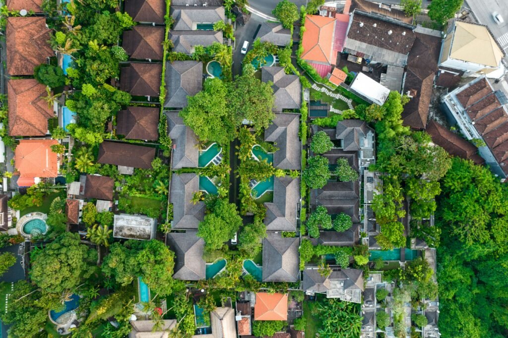 Aerial view of dense villas and swimming pools in Bali, illustrating the pressure tourism development places on the island’s water resources.

