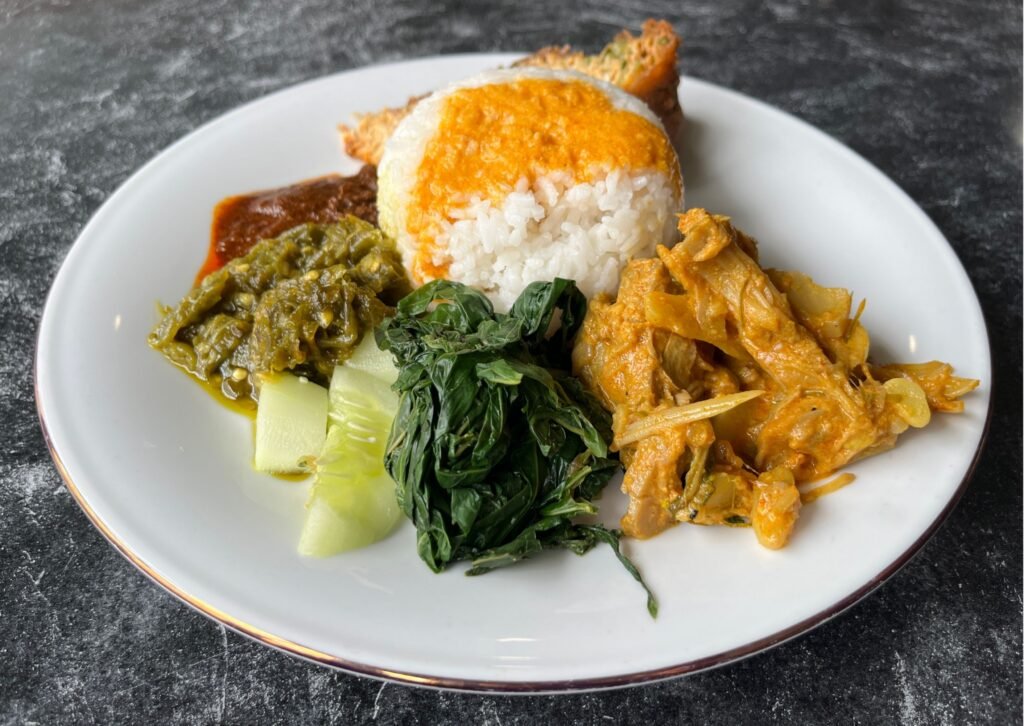 jackfruit plate called gulai nangka, at a waring Padang. Vegetarian food in Indonesia.