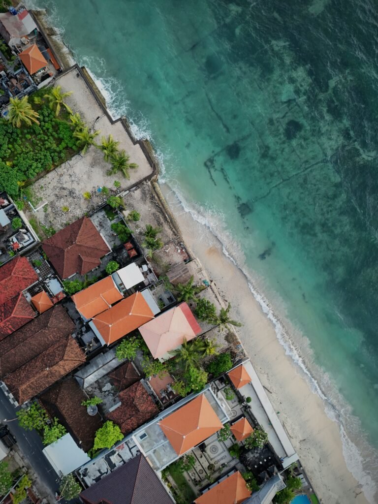 Aerial view of dense coastal development along the shoreline in Bali, Indonesia.